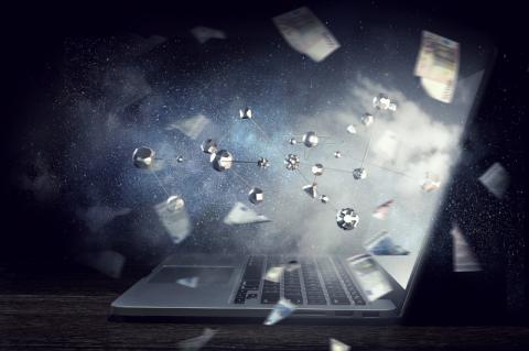 Ein geöffneter Laptop, dessen Bildschirm von Metallkugeln durchschlagen wird.